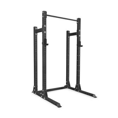 The Bells of Steel Hydra Half Rack Builder (3" x 3", ⅝" holes) is a black metal power rack with adjustable upright posts, a top pull-up bar, and safety catches—ideal for weightlifting in your home gym.