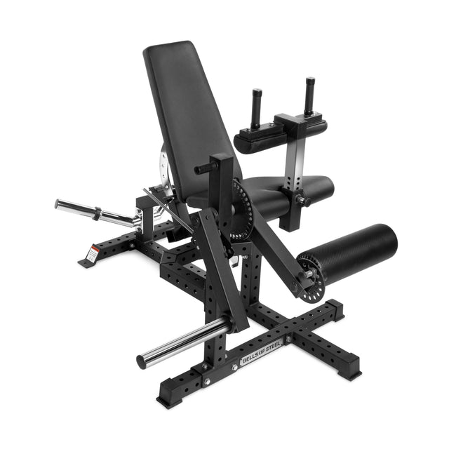 The Bells of Steel Legacy Leg Extension / Hamstring Curl Machine is a plate-loaded, black, adjustable machine with padded seat and backrest, steel frame, handles, and rollers—ideal for home gym leg extensions and curls.